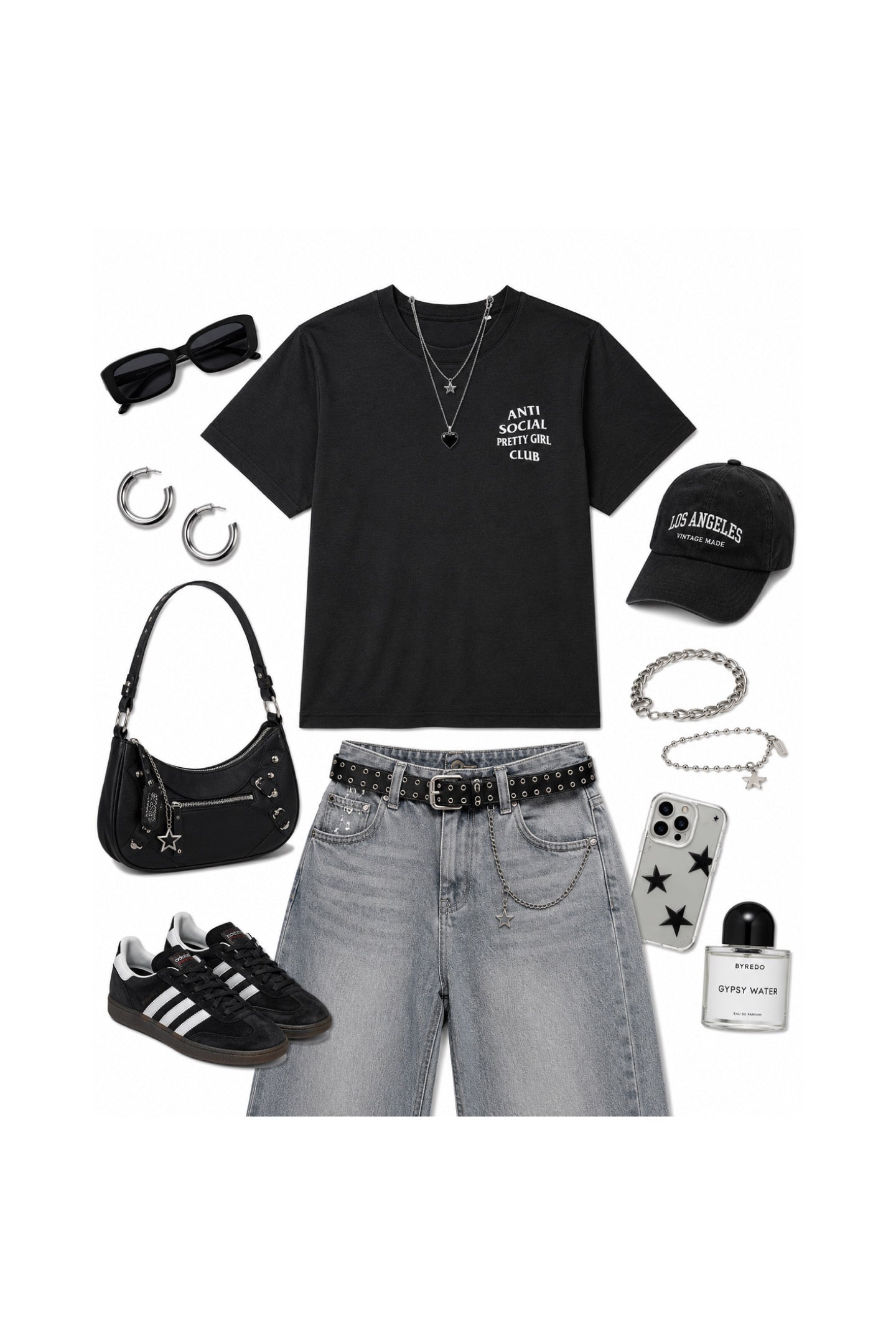 A styled flat-lay outfit on a white background featuring a black graphic t-shirt, light-wash denim shorts, a black studded belt, black sneakers, a black handbag, sunglasses, hoop earrings, a baseball cap, layered necklaces, a phone case, and a perfume bottle.