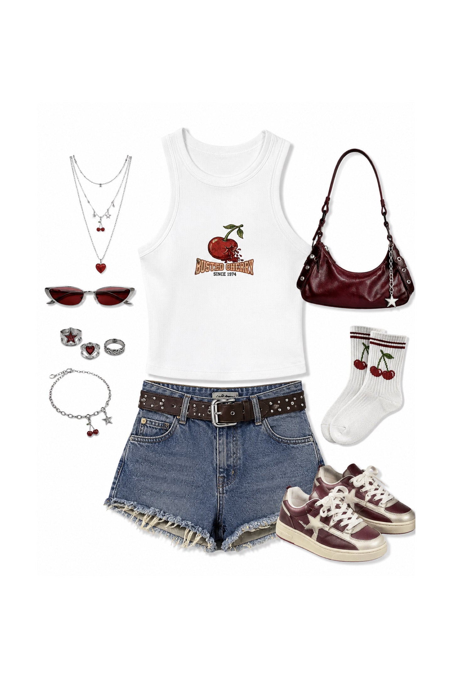 A flat lay outfit arrangement on a white background featuring a white tank top with a red apple graphic, blue denim shorts, a dark brown studded belt, white socks with red cherries, burgundy sneakers, a burgundy shoulder bag, sunglasses, layered necklaces, rings, and a bracelet.