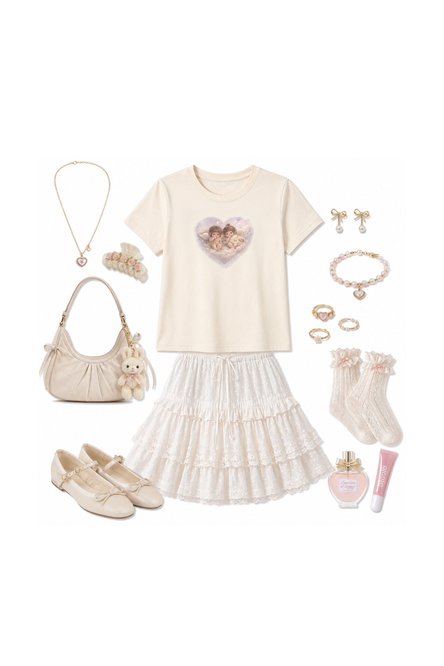 A girls' outfit flat lay featuring a cream short-sleeve t-shirt with a heart-shaped cherub graphic, a white tiered ruffle skirt, cream Mary Jane shoes, a cream shoulder bag, a gold necklace, pearl-style earrings, a pearl bracelet, and a pink lip balm, all arranged on a solid white background.