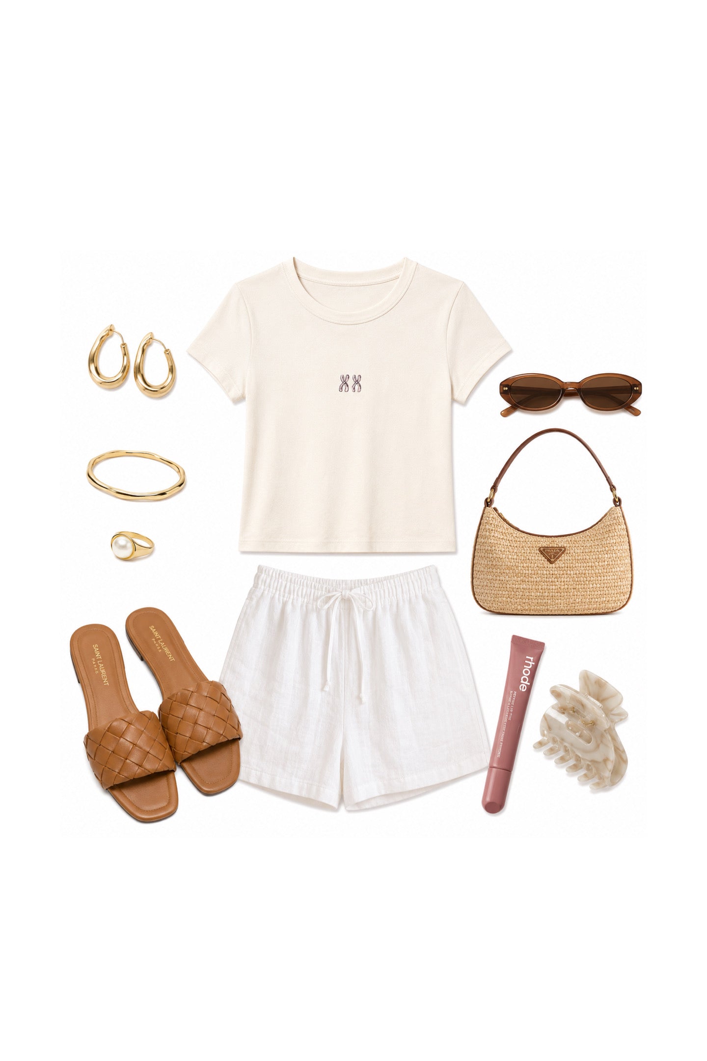 A styled flat lay outfit on a white background featuring a cream short-sleeve crop top with a small black monogram, white shorts, brown slide sandals, a woven straw handbag, gold hoop earrings, a gold bangle, a pink tube, sunglasses, and a white scrunchie.